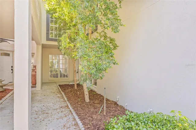 a porch with a tree in front of it