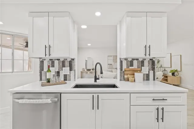 a kitchen with cabinets a sink and a window
