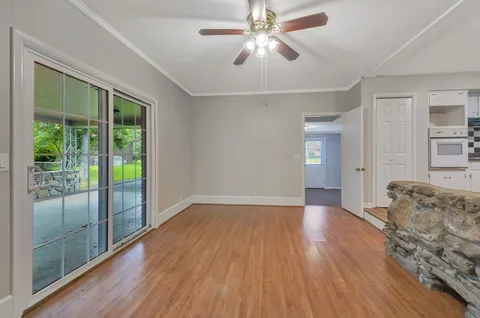 a view of livingroom with hardwood floor and ceiling fan