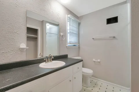a bathroom with a sink toilet and shower