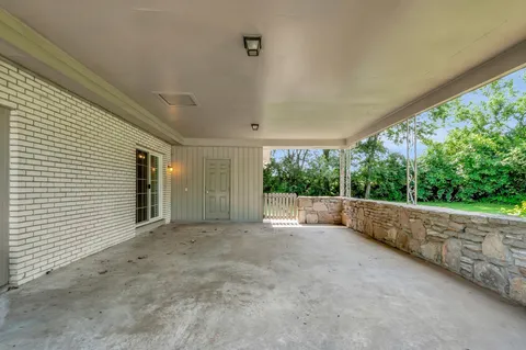 a view of an empty room with a floor to ceiling window