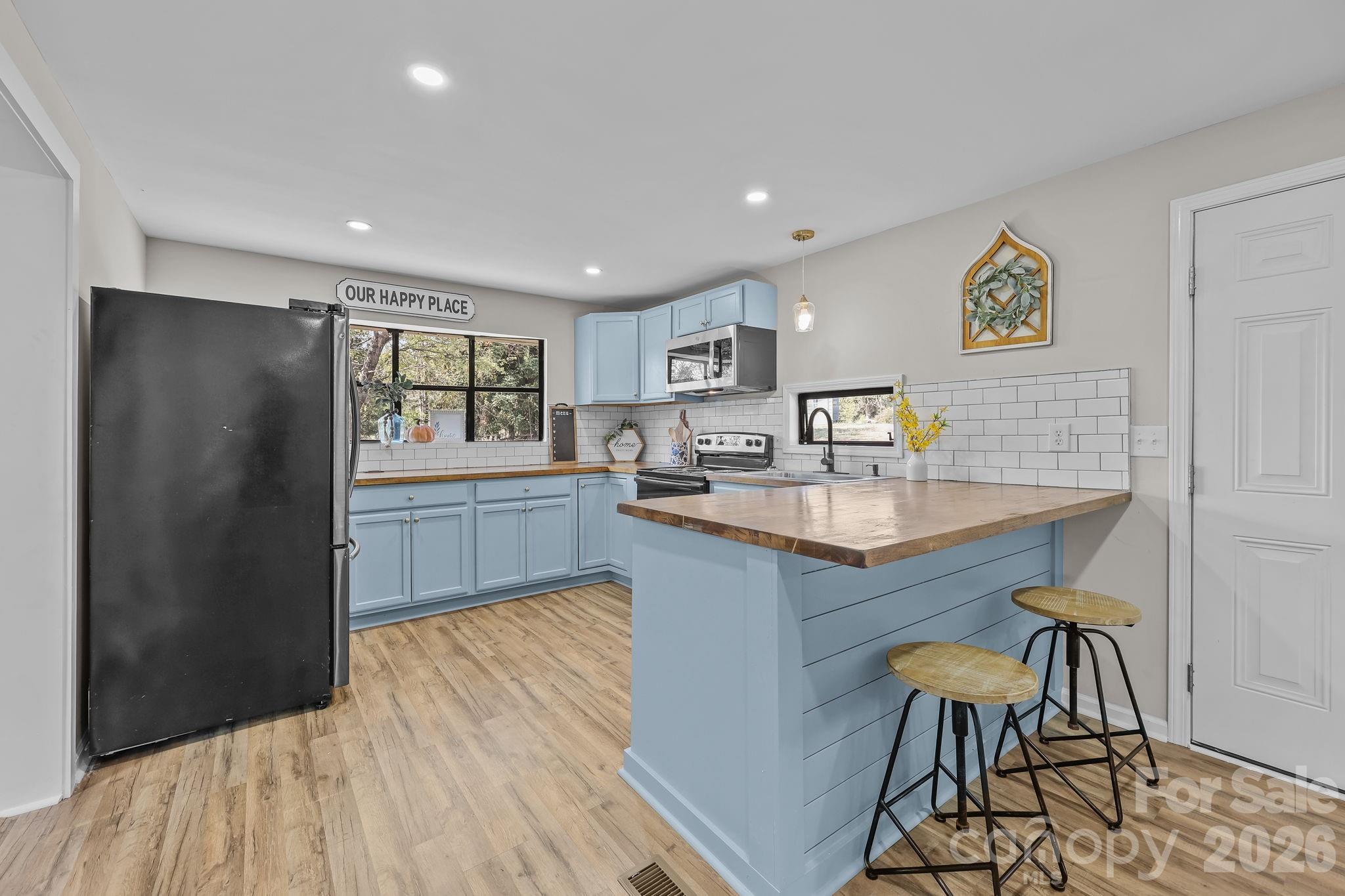 1315 King Road Salisbury, NC 28146 - Photo 12 of 41 a kitchen with granite countertop a sink cabinets and wooden floor