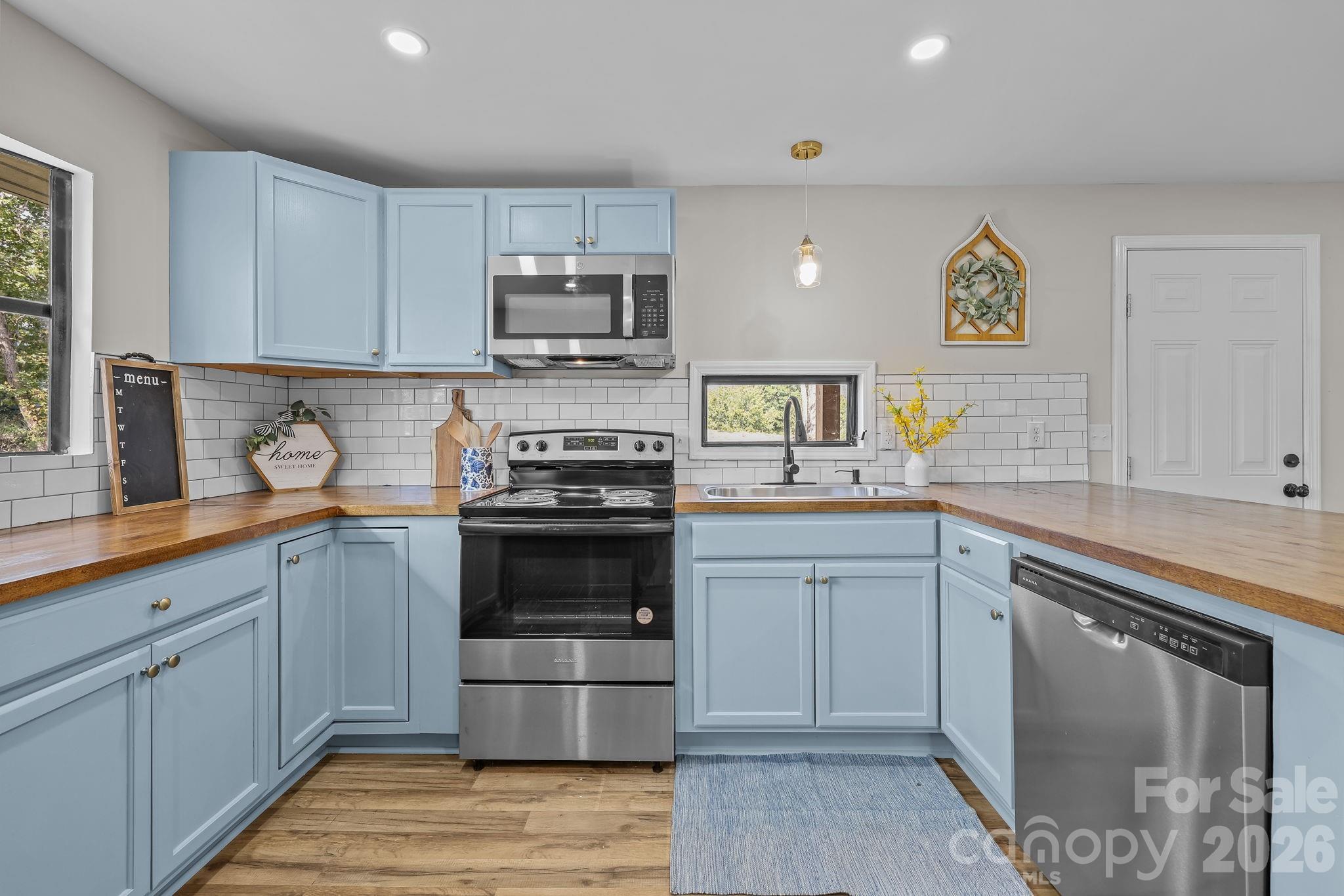 1315 King Road Salisbury, NC 28146 - Photo 13 of 41 a kitchen with stainless steel appliances granite countertop a stove sink and cabinets