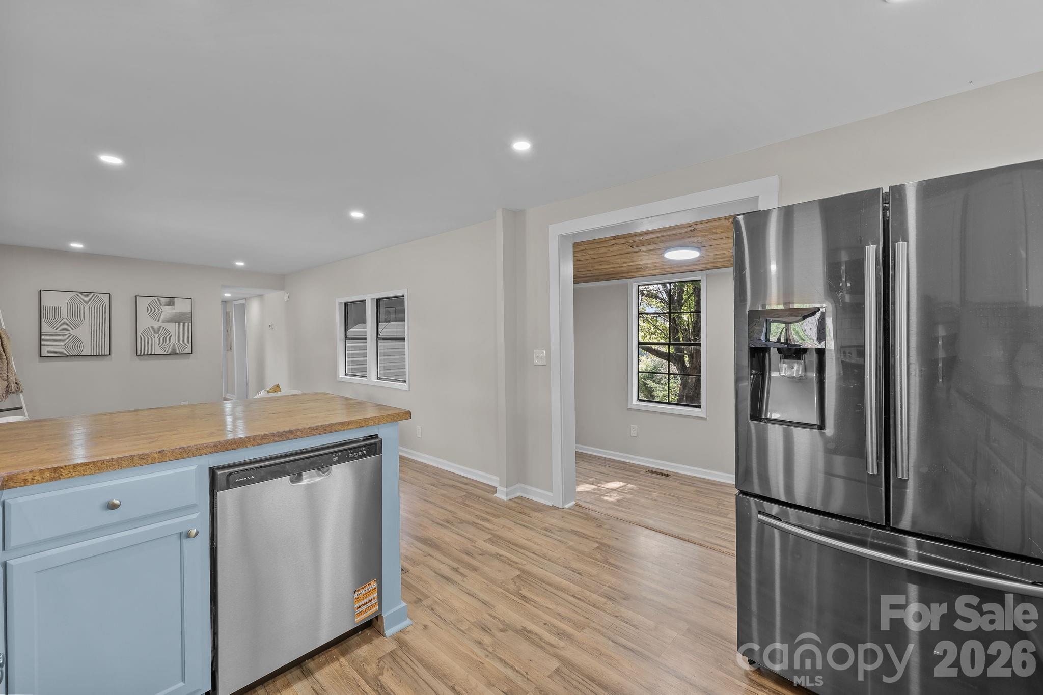 1315 King Road Salisbury, NC 28146 - Photo 14 of 41 a kitchen with kitchen island a counter top space wooden floor and stainless steel appliances