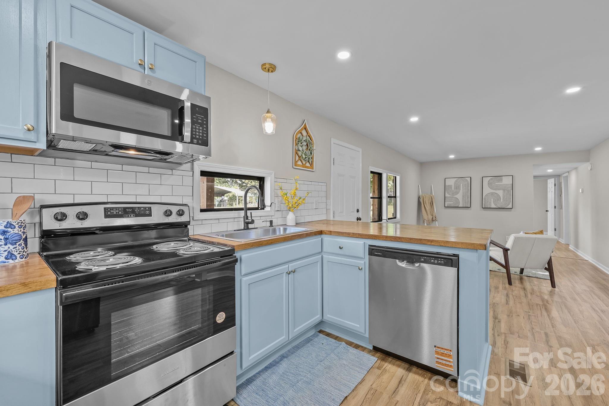 1315 King Road Salisbury, NC 28146 - Photo 15 of 41 a kitchen with stainless steel appliances granite countertop a stove top oven microwave and cabinets