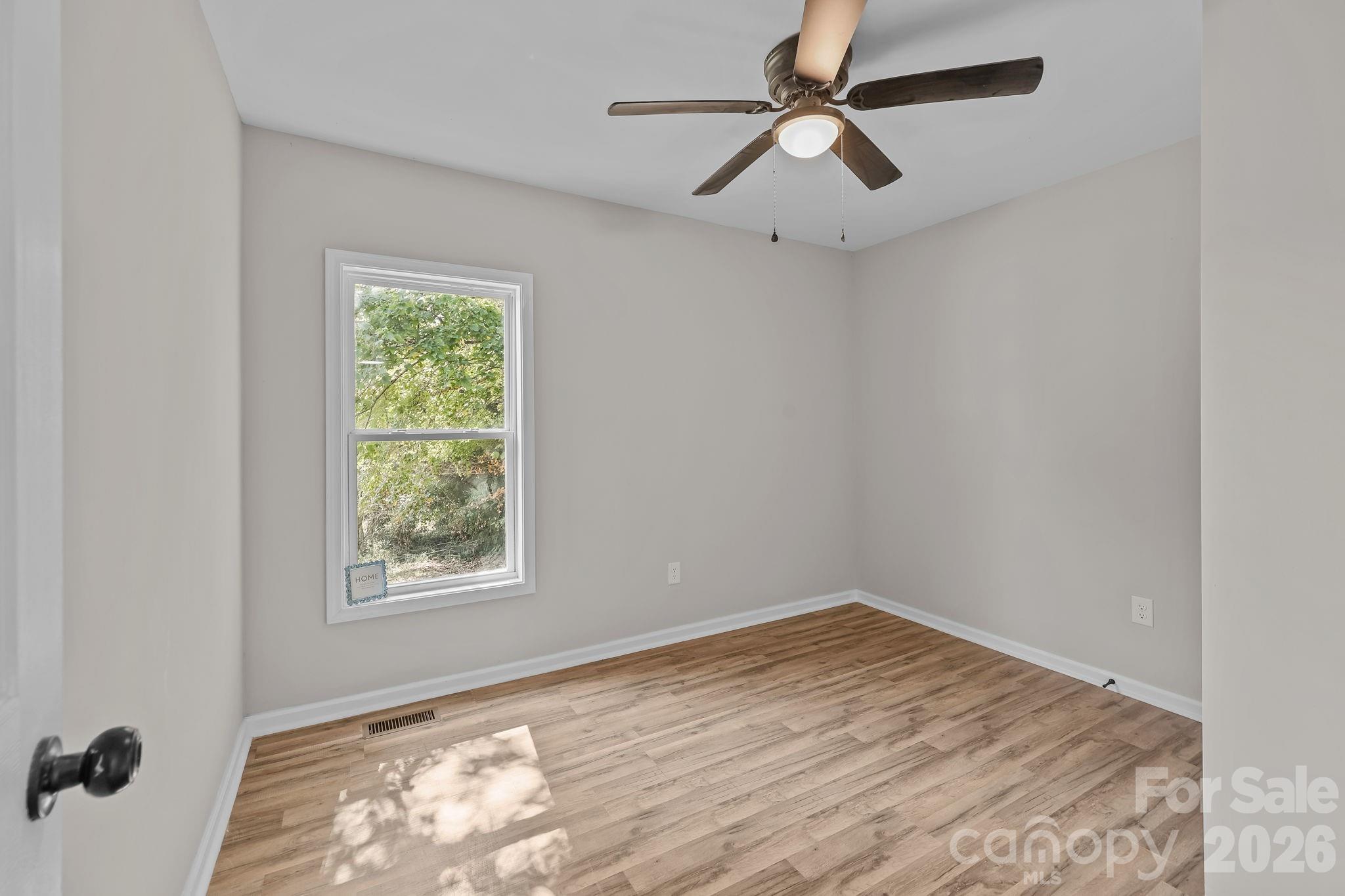 1315 King Road Salisbury, NC 28146 - Photo 20 of 41 an empty room with a window and a fan