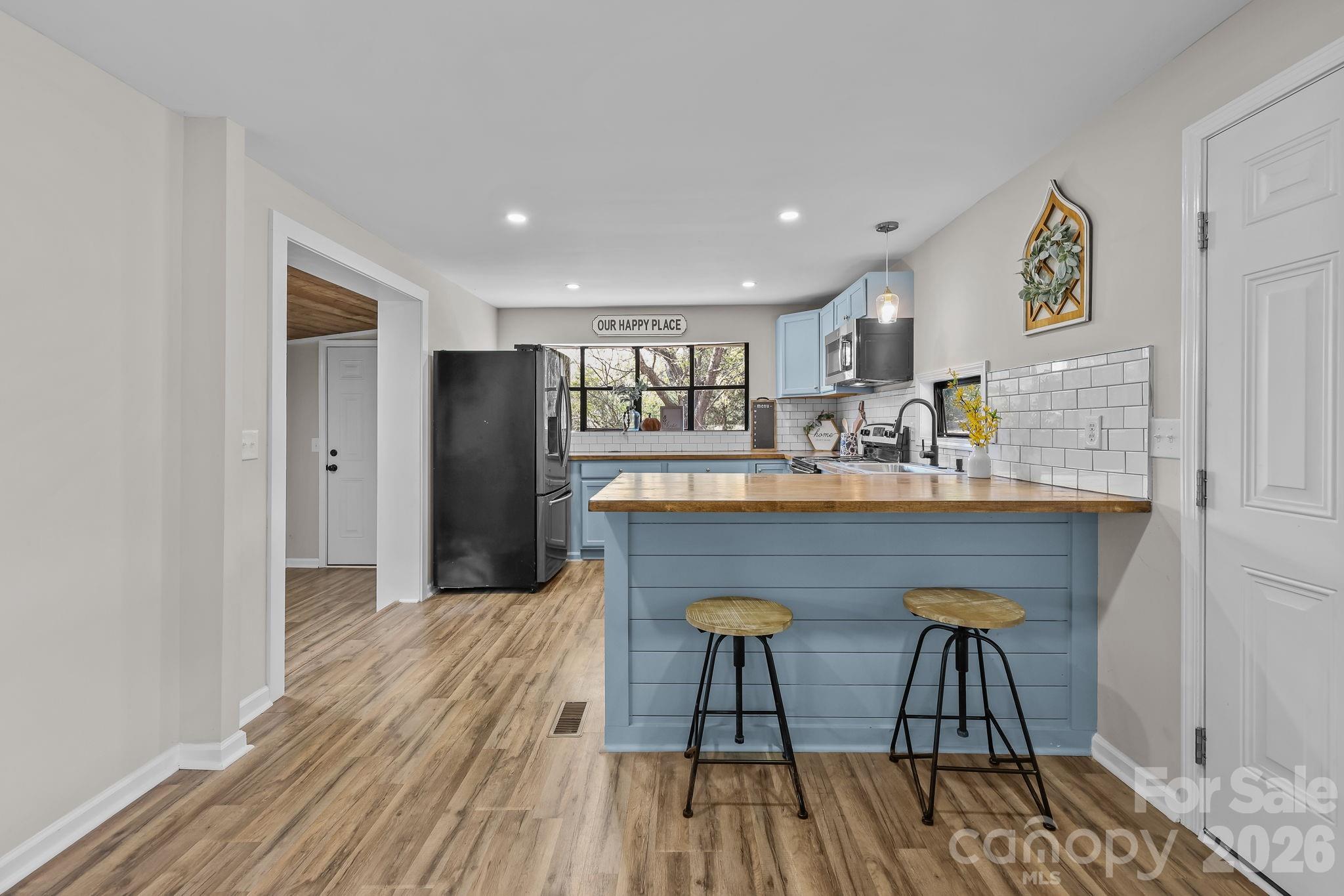 1315 King Road Salisbury, NC 28146 - Photo 2 of 41 a kitchen with stainless steel appliances granite countertop a kitchen island a hardwood floor and a sink