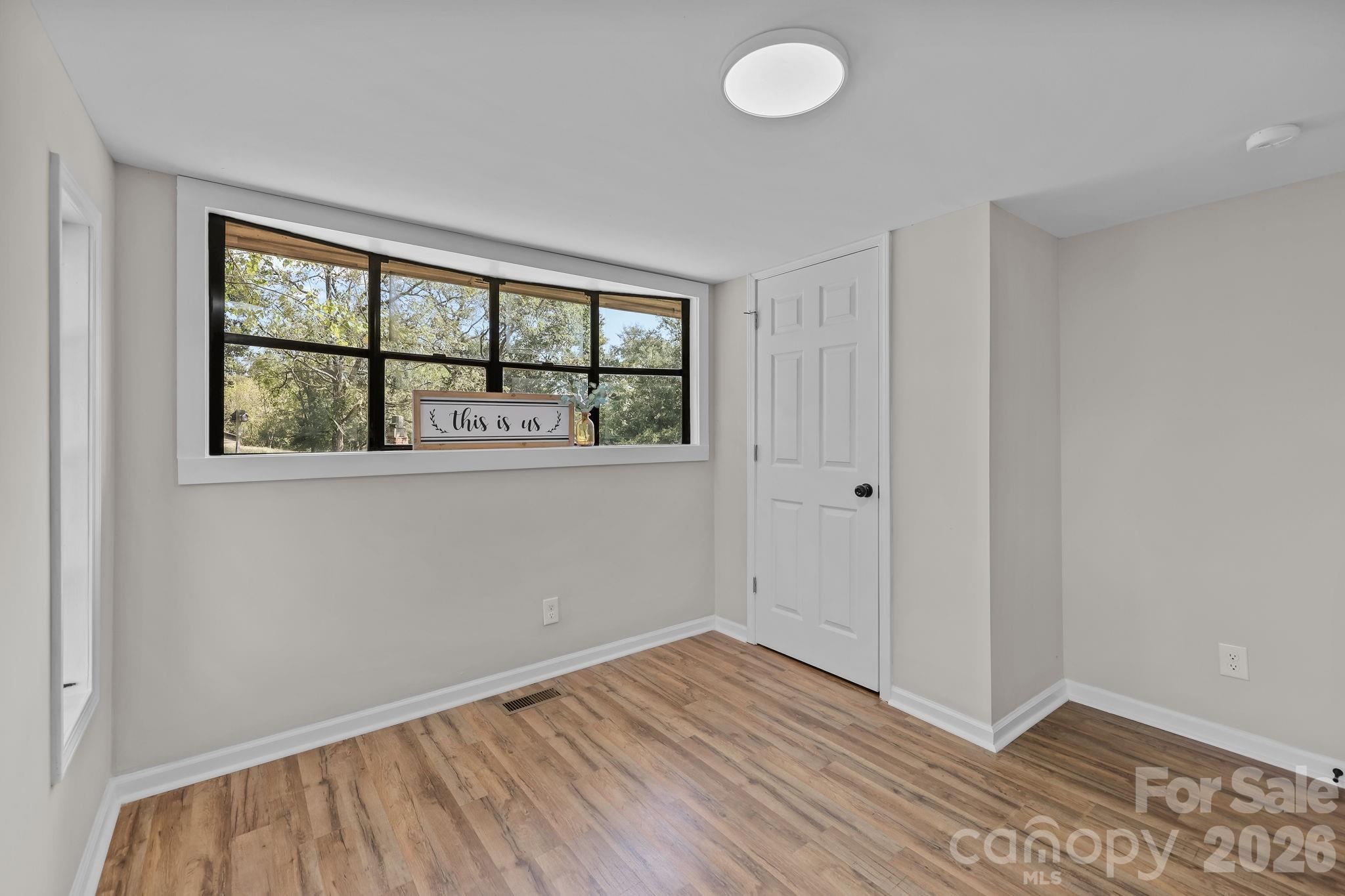 1315 King Road Salisbury, NC 28146 - Photo 25 of 41 an empty room with wooden floor and windows
