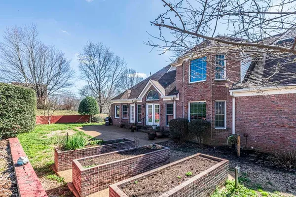 a front view of a house with garden