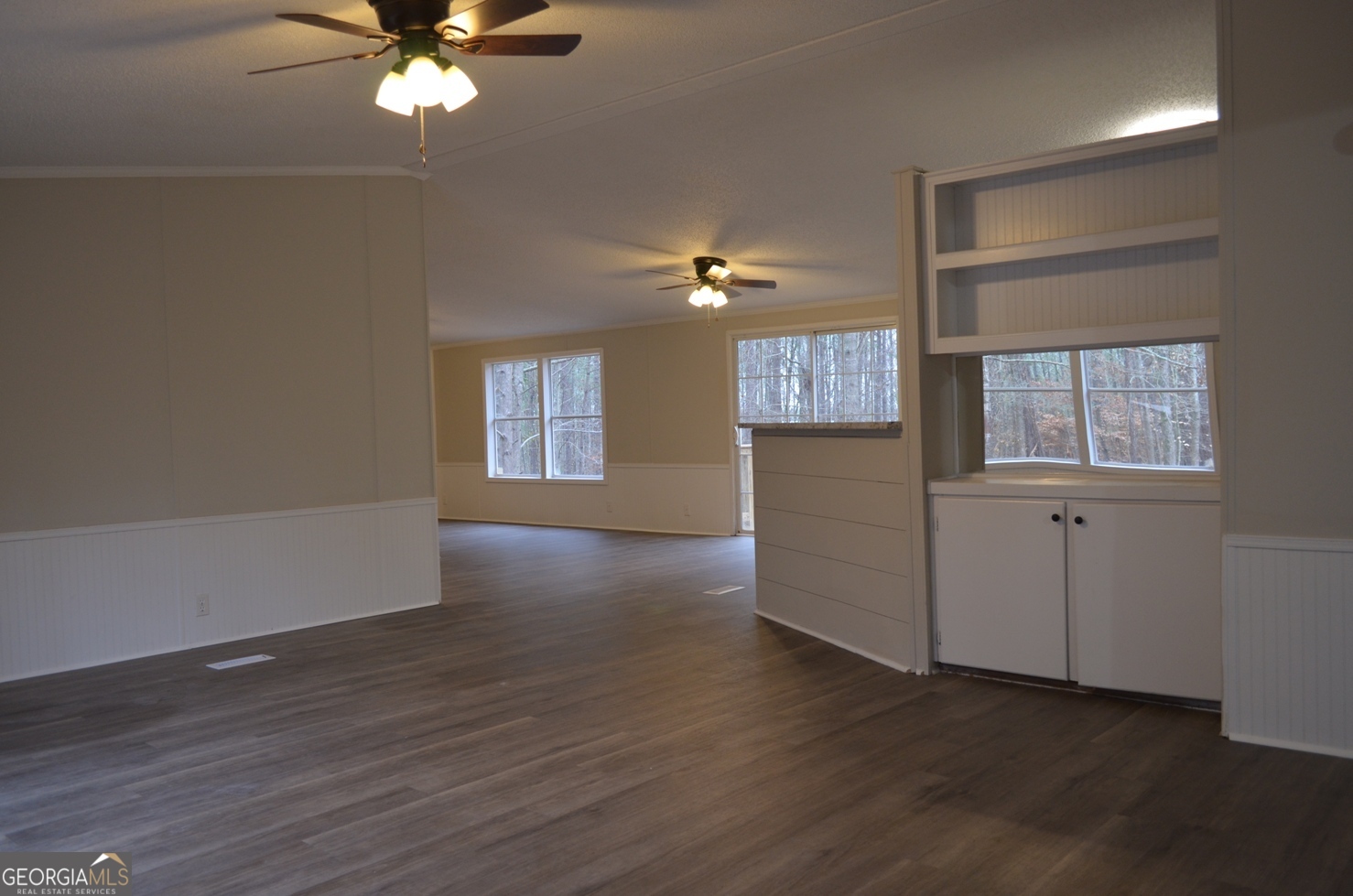 1048 Lee King Road Forsyth, GA 31029 - Photo 3 of 19 a view of an empty room with a window and wooden floor