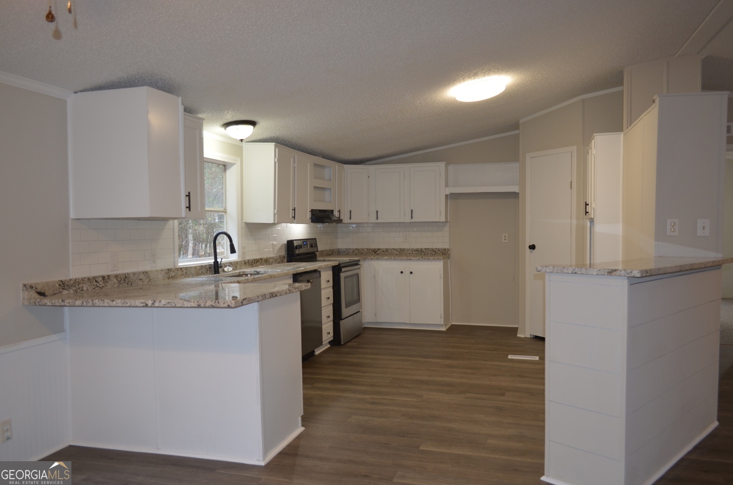 1048 Lee King Road Forsyth, GA 31029 - Photo 4 of 19 a kitchen with stainless steel appliances granite countertop a sink stove and refrigerator