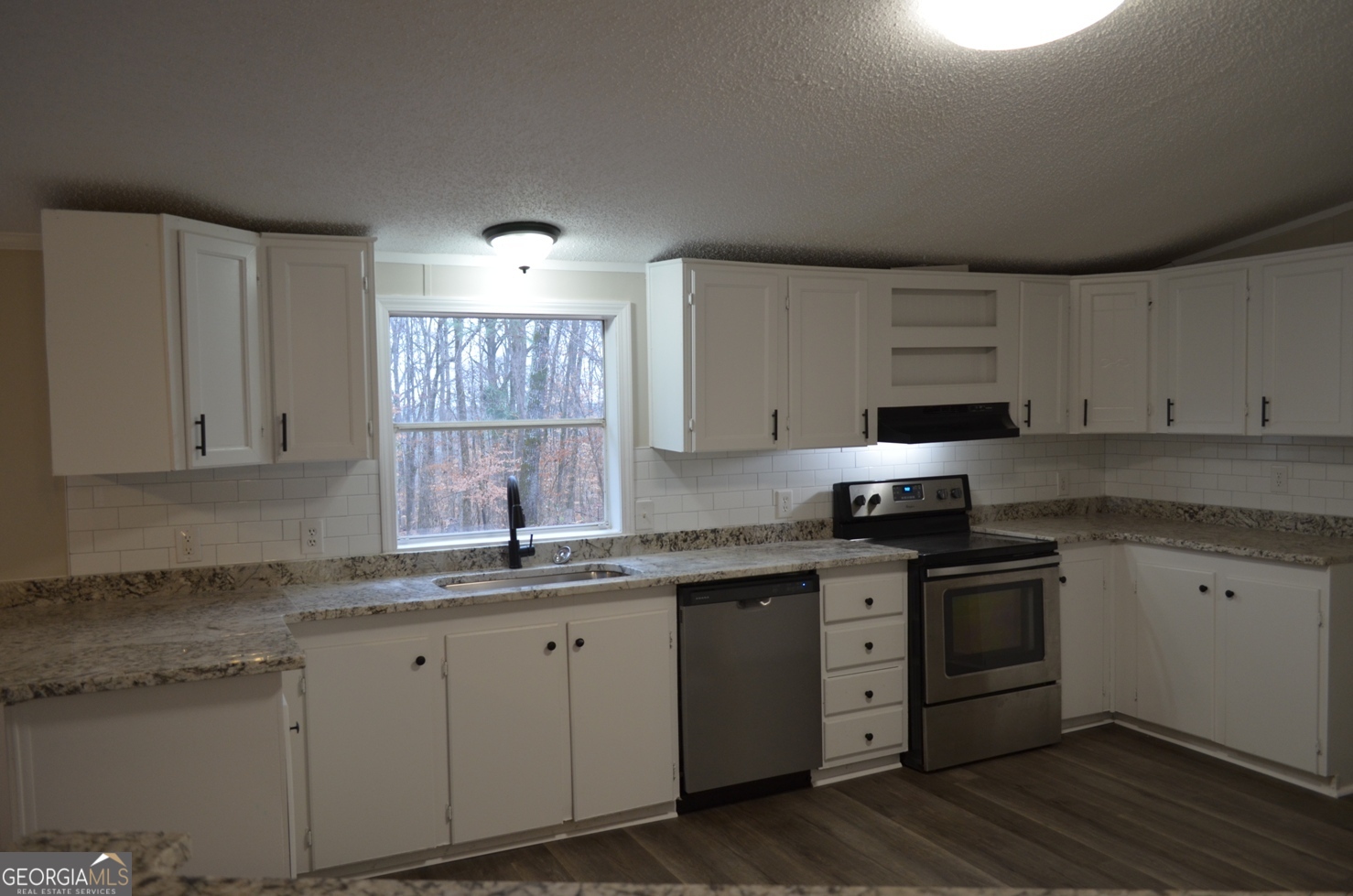 1048 Lee King Road Forsyth, GA 31029 - Photo 5 of 19 a kitchen with cabinets appliances a sink and a window