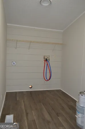 a view of a room with wooden floor