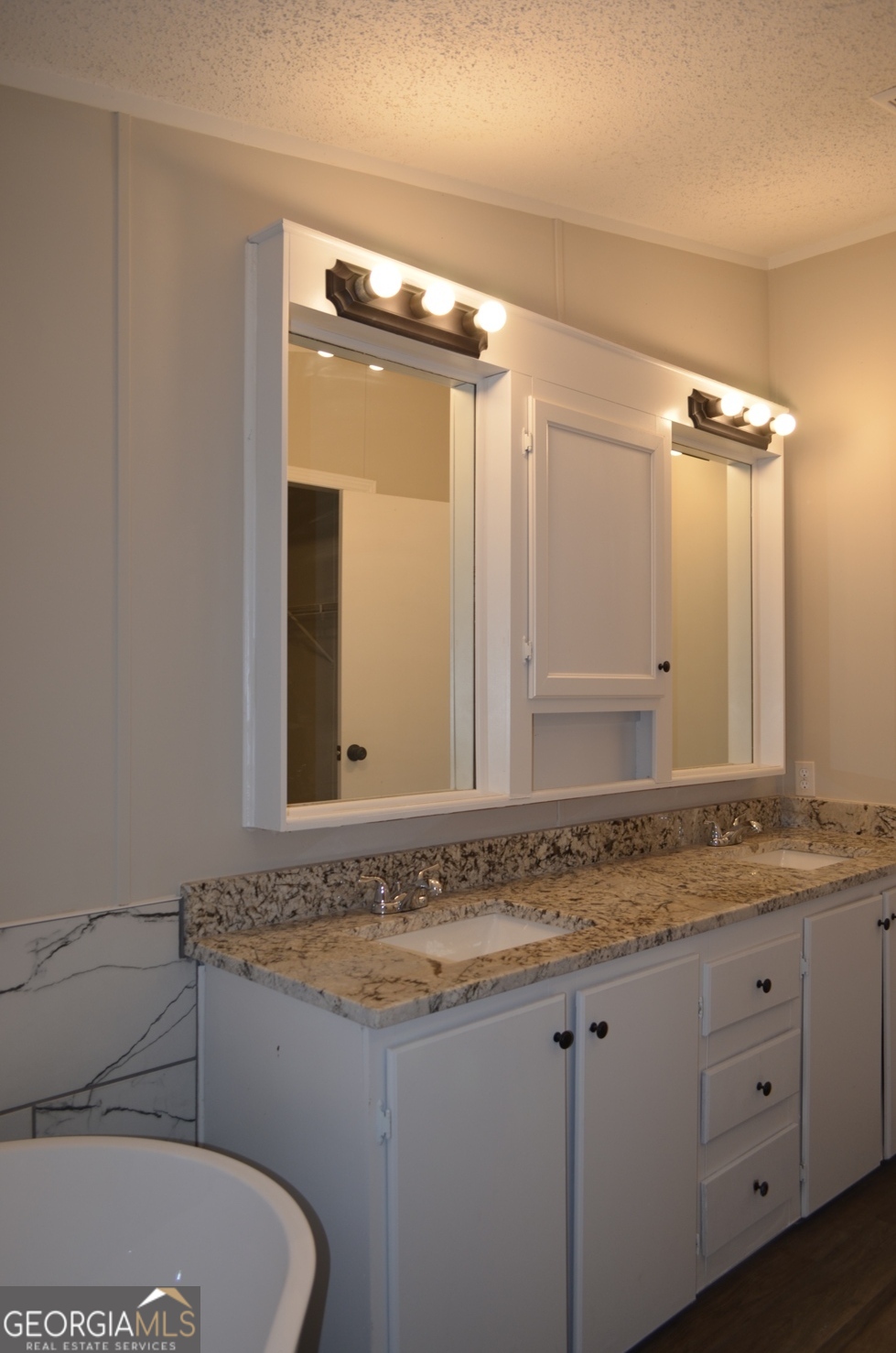 1048 Lee King Road Forsyth, GA 31029 - Photo 10 of 19 a bathroom with a granite countertop sink and a mirror
