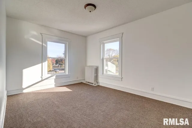 a view of a porch with a floor to ceiling window and wooden fence