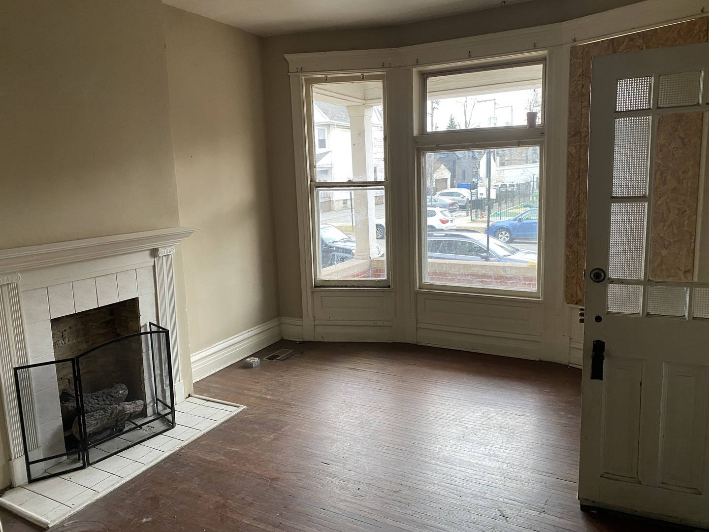 1522 West Wilson Avenue Chicago, IL 60640 - Photo 12 of 27 an empty room with wooden floor fireplace and windows