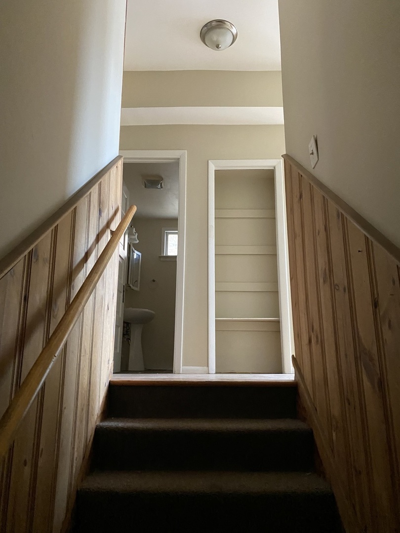 1522 West Wilson Avenue Chicago, IL 60640 - Photo 23 of 27 a view of staircase with wooden floor and a window