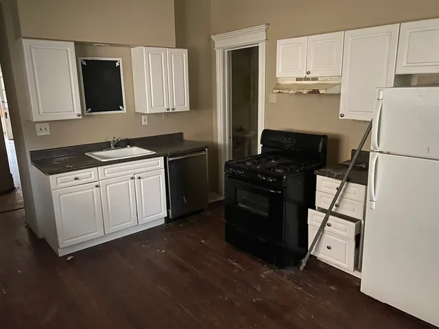 a kitchen with a sink a stove and refrigerator
