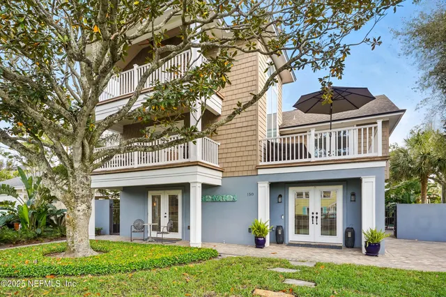 front view of a brick house with a yard