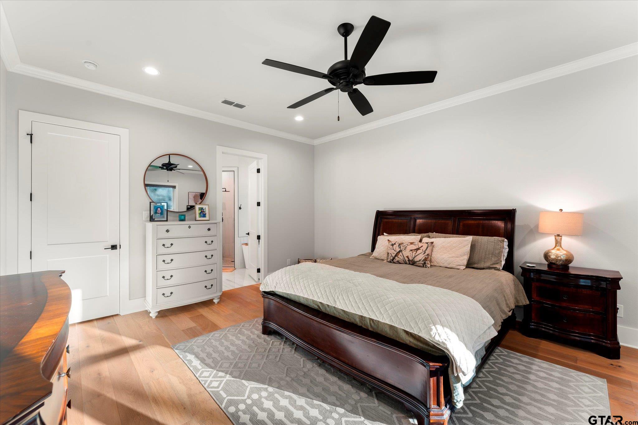 4301 Windrush Boulevard Longview, TX 75604 - Photo 16 of 36 a large bedroom with a bed and wooden floor