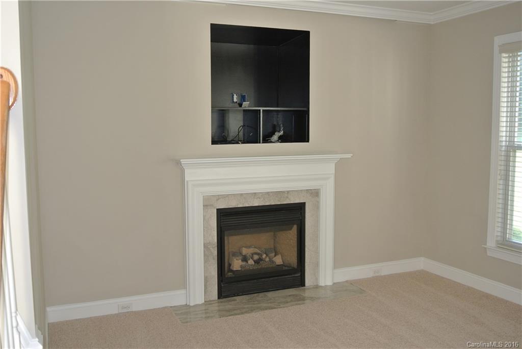 10100 White Cascade Drive Charlotte, NC 28269 - Photo 5 of 19 a living room with a fireplace and a window