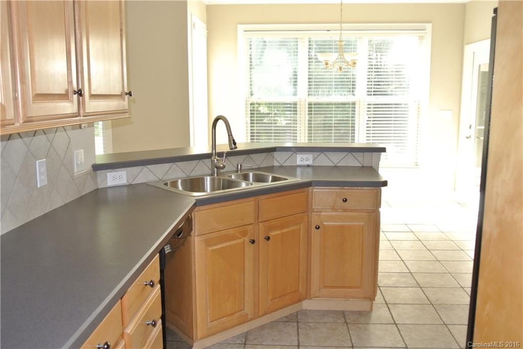 10100 White Cascade Drive Charlotte, NC 28269 - Photo 8 of 19 a kitchen with granite countertop a sink and a stove