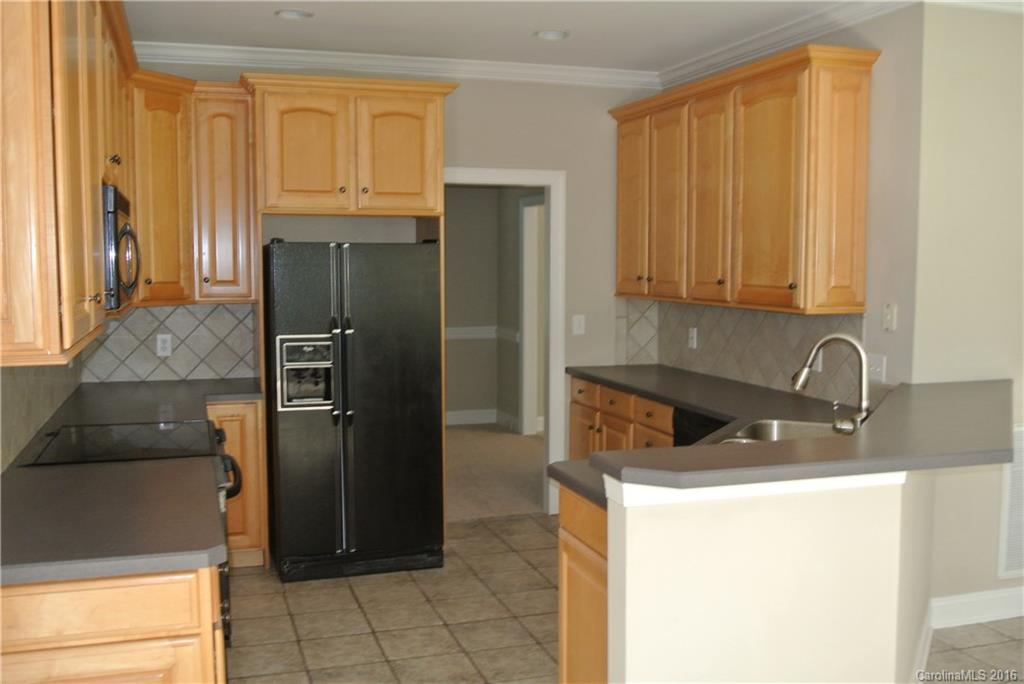10100 White Cascade Drive Charlotte, NC 28269 - Photo 10 of 19 a kitchen with a refrigerator and a sink