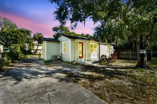 a backyard of a house with table and chairs