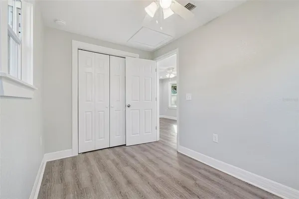 a view of an empty room with wooden floor
