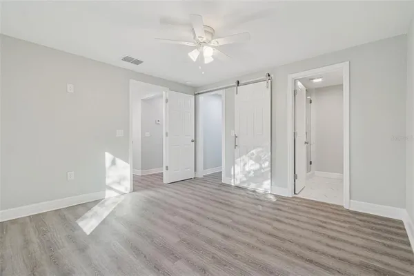a view of an empty room with wooden floor