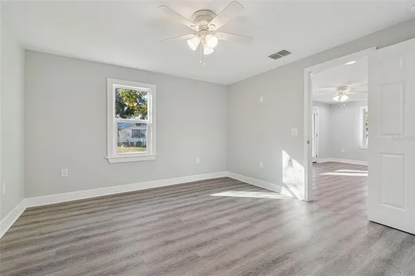 wooden floor in an empty room with a window