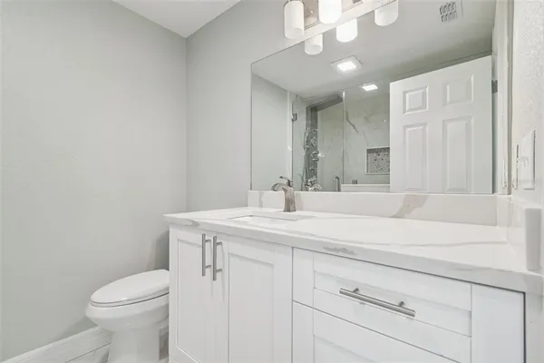 a bathroom with a sink a toilet and a mirror
