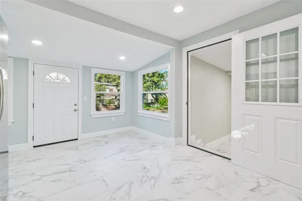 an empty room with windows and closet