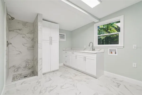 a bathroom with a sink a toilet and shower