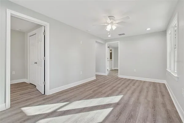 wooden floor in an empty room with a window