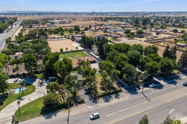 a swimming pool with outdoor seating and yard
