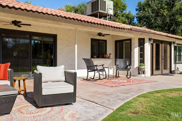 a dining room with furniture potted plants and wooden floor