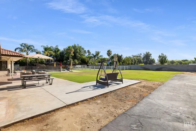 a kitchen with stainless steel appliances granite countertop a stove refrigerator and a sink