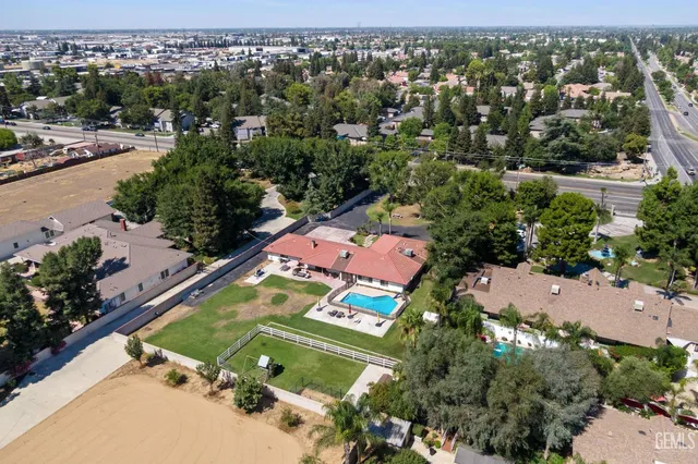 a kitchen with stainless steel appliances granite countertop a sink refrigerator stove and microwave