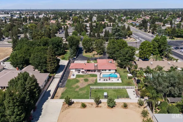 a kitchen with stainless steel appliances kitchen island granite countertop a refrigerator and a stove top oven