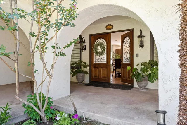 a living room with furniture a flat screen tv and kitchen view