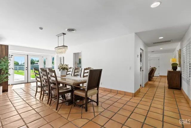 a living room with furniture a fireplace and a large window