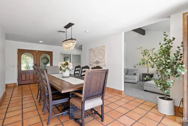 a living room with furniture a fireplace and a potted plant