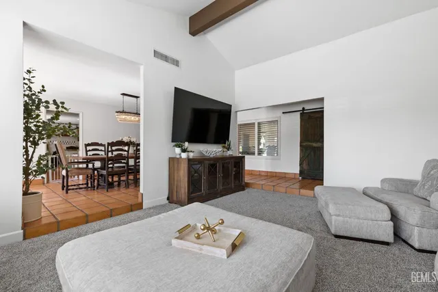a living room with furniture and a chandelier