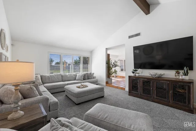 a spacious bedroom with a bed and a window