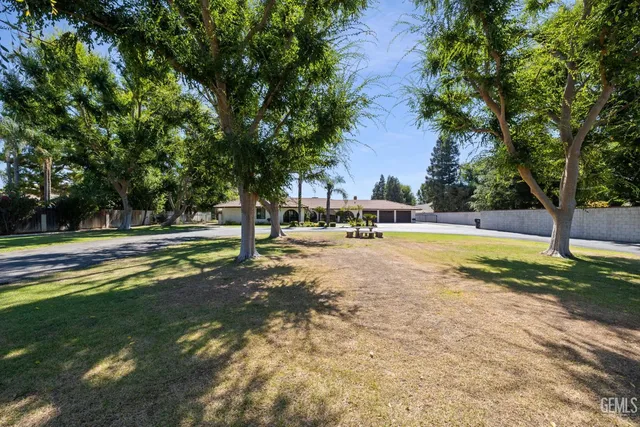 a view of swimming pool with outdoor seating and trees