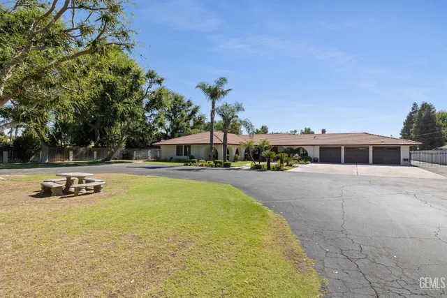 a view of a house with swimming pool and sitting area