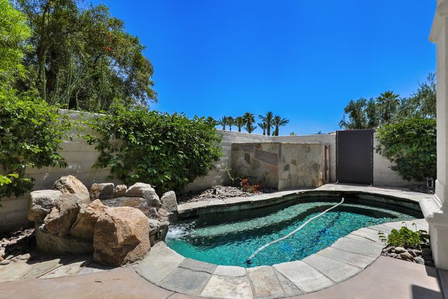 a backyard of a house with table and chairs
