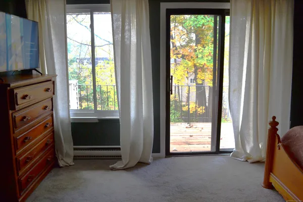 a view of room with window and a flat screen tv