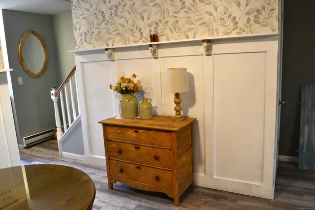 a room with a mirror and furniture